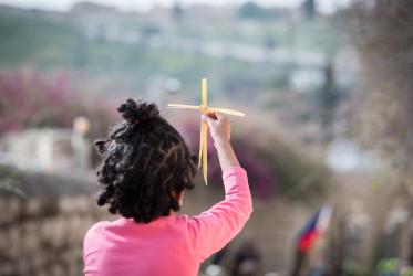 a child holds cross