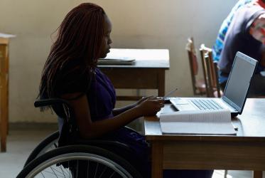 Woman in a wheelchair in a classroom